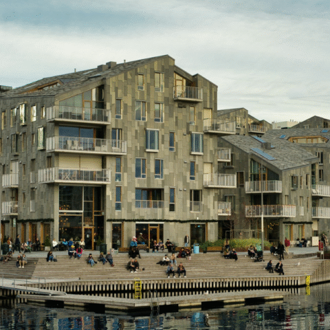 Waterfront architecture featuring urban buildings and infrastructure interacting with water in a modern coastal setting.