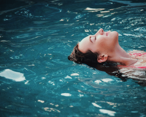 Woman floating in calm water, viewed from above, evoking the stillness associated with meditative swimming