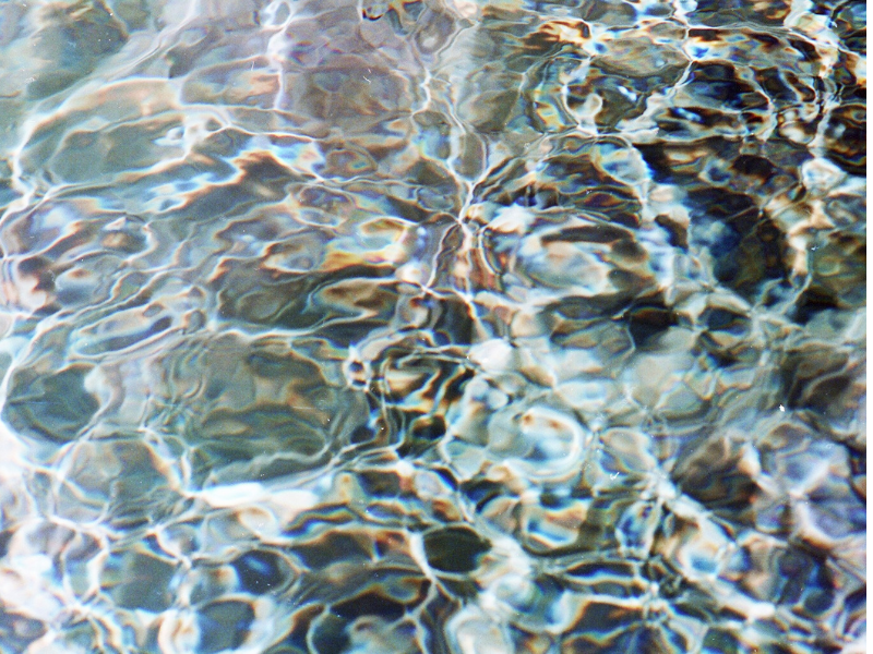 Close-up of a calm pool of water illustrating water age and the subtle changes in water quality over time, photographed by Caroline Turnbull.