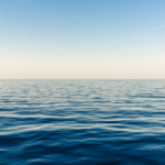 A calm water body with a smooth surface, illustrating water age and the effects of time on still water.