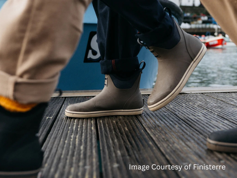 A person walking with Finisterre and XTRATUF coastal boot