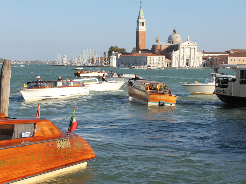 Brown and white boats sailing on open water during daytime, reflecting the role of water taxis and small passenger boats in coastal and urban water transport.