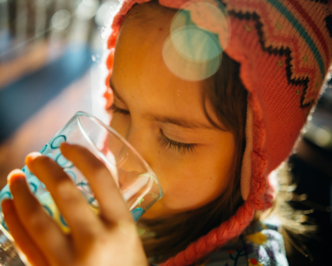 How Long Can You Survive Without Water? A girl drinking water from a bottle to stay hydrated.
