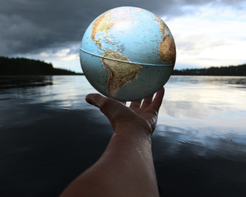 Person holding a clear glass ball symbolising water and sustainability for World Water Day 2026