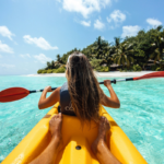 Woman on a kayak enjoying water sports on calm open water