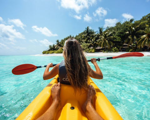 Woman on a kayak enjoying water sports on calm open water