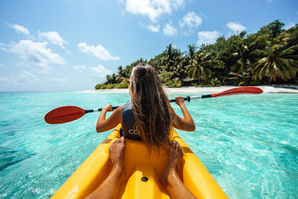 Woman on a kayak enjoying water sports on calm open water