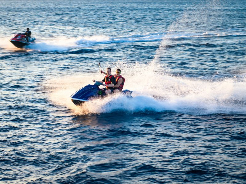 Two men riding on a jet ski during exciting water sports activities on open water