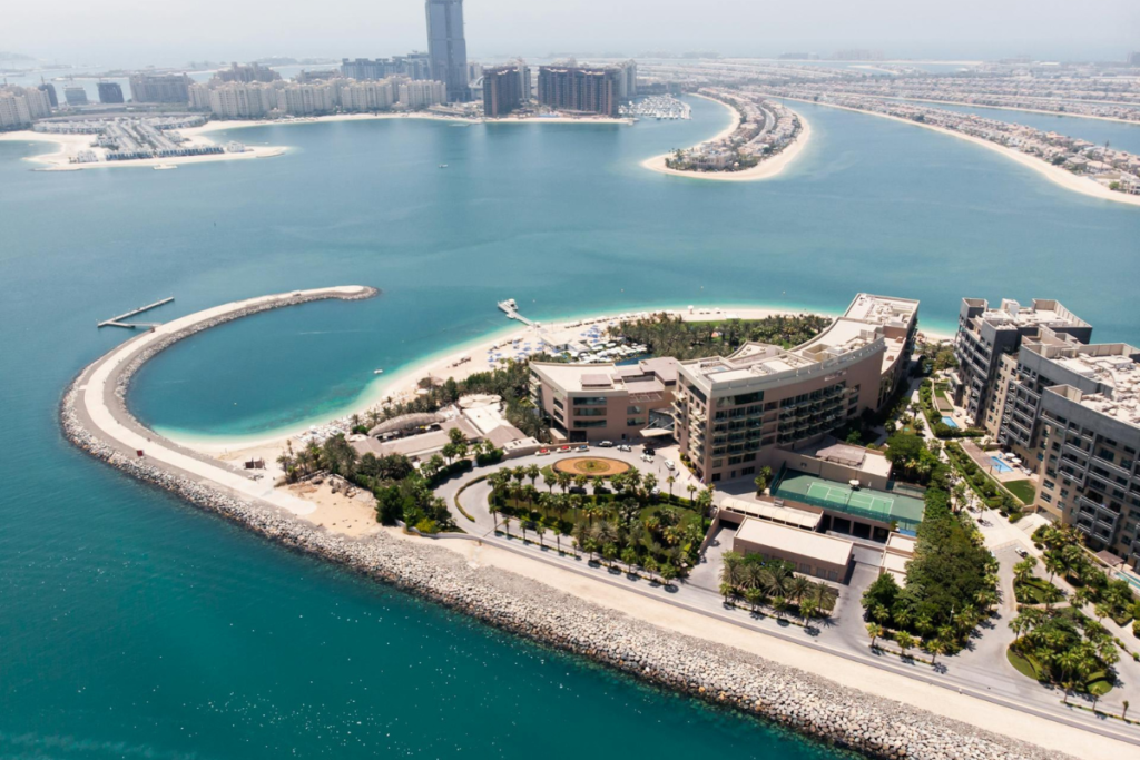 Aerial view of Palm Jumeirah’s artificial beaches and luxury waterfront developments along the Dubai coastline.