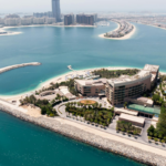 Aerial view of Palm Jumeirah’s artificial beaches and luxury waterfront developments along the Dubai coastline.
