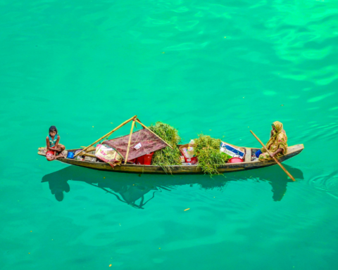 Floating markets in Bangladesh where a boat vendor transports fresh produce, highlighting traditional water-based trade and community livelihoods.