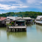 Traditional stilt houses built above water in a coastal settlement.