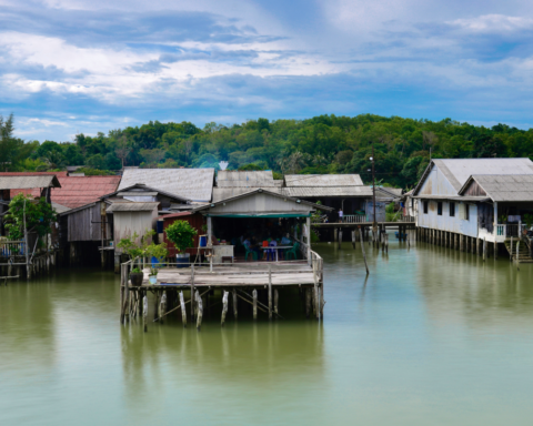 Traditional stilt houses built above water in a coastal settlement.