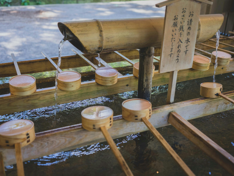 Traditional Japanese water purification ladles highlight the rituals of cleanliness and respect surrounding communal bathing culture.
