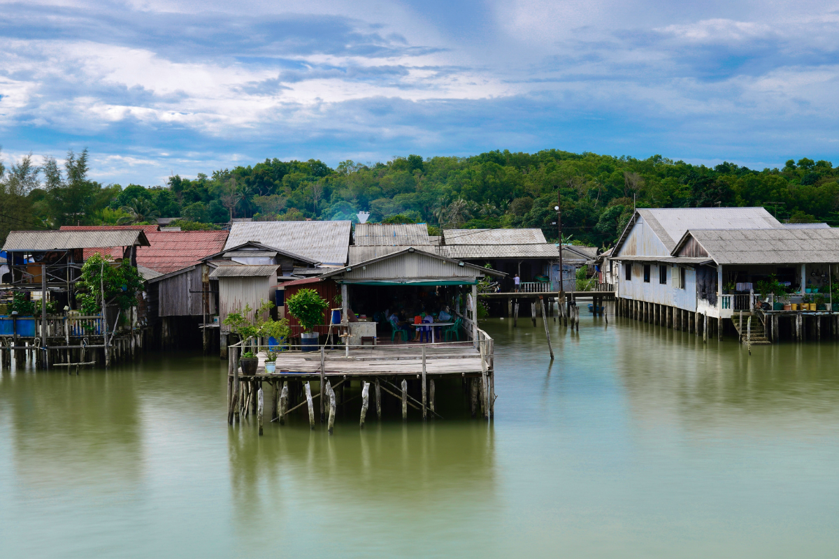 Traditional stilt houses built above water in a coastal settlement.