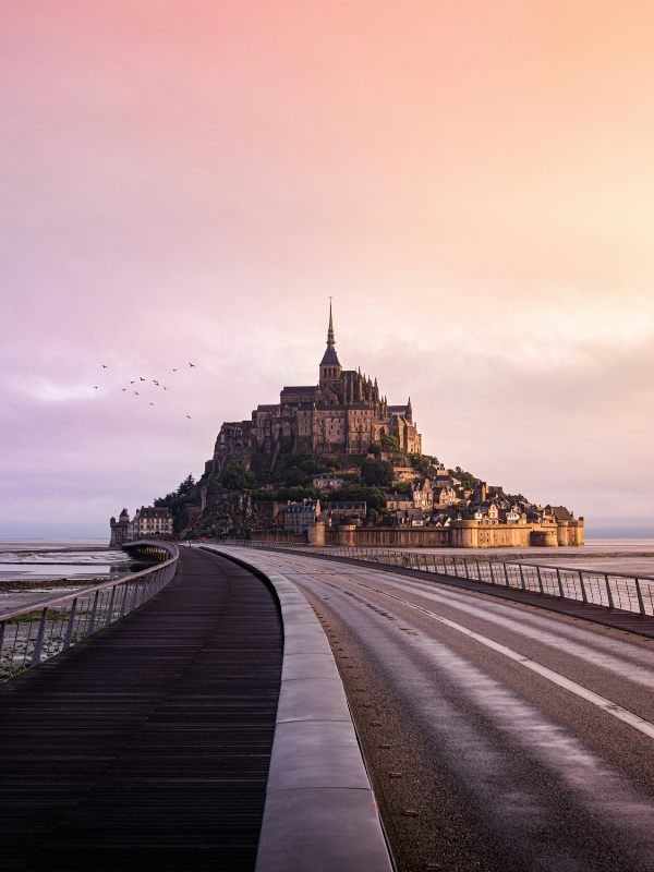 Mont Saint-Michel rises above the surrounding bay, where the changing tide continually transforms the landscape between land and sea.