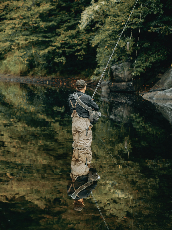 A fly fisher stands in a quiet river, where fish, flowing water and human activity all contribute to the changing freshwater soundscape.